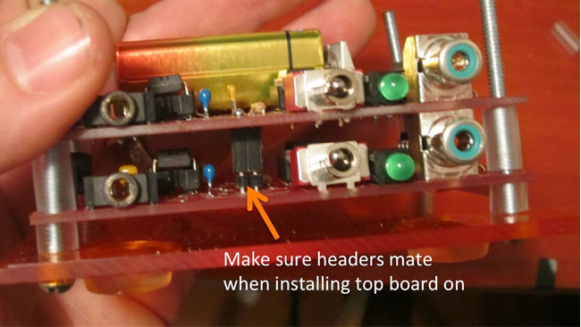 Slide top board through screws and on top of bottom board, and ensure the connections mate.