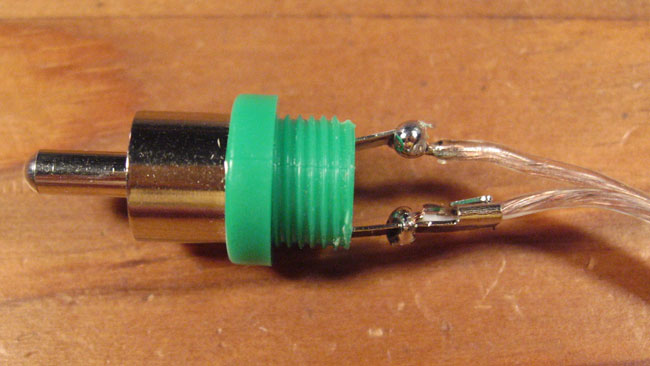 Place wire in eyelets of RCA connector, solder, and crimp where applicable.  Take care that the connections are both strong and not touching each other.